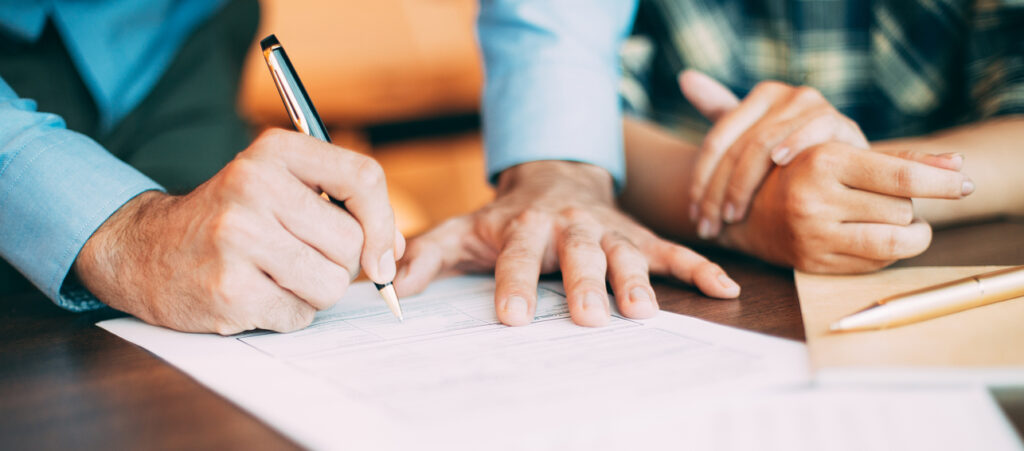 Senior candidate filling application form at table